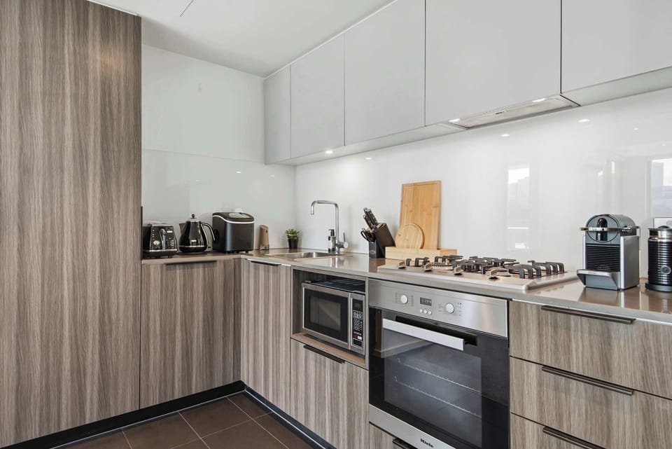 Modern, fully equipped kitchen with sleek cabinetry, quality appliances, and ample counter space—perfect for preparing meals and enjoying a comfortable stay.