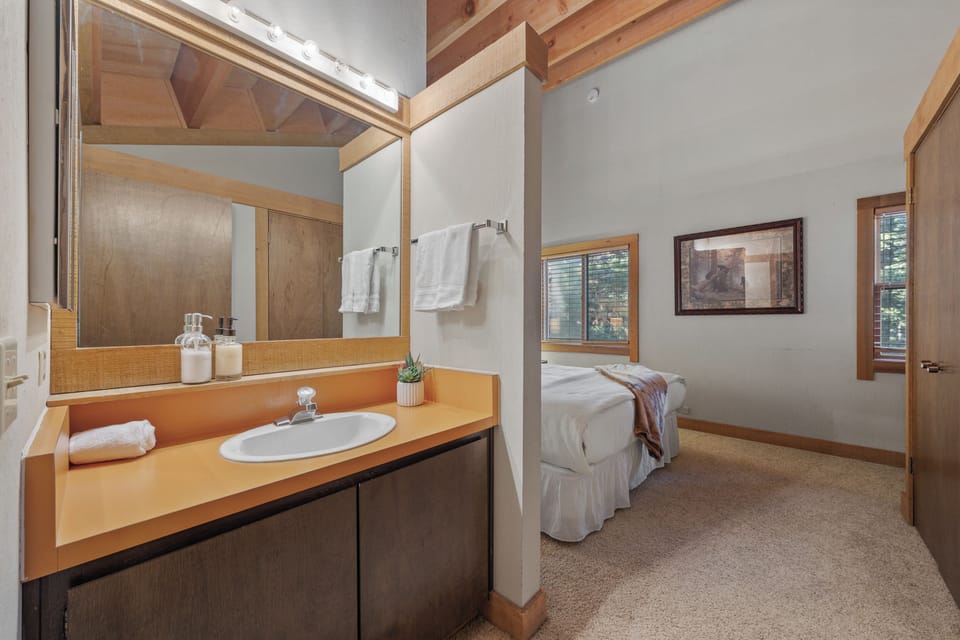 The primary bedroom features a king bed with a vanity nook.