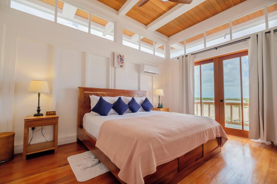 Wake to sunlit serenity and ocean views from your bed.