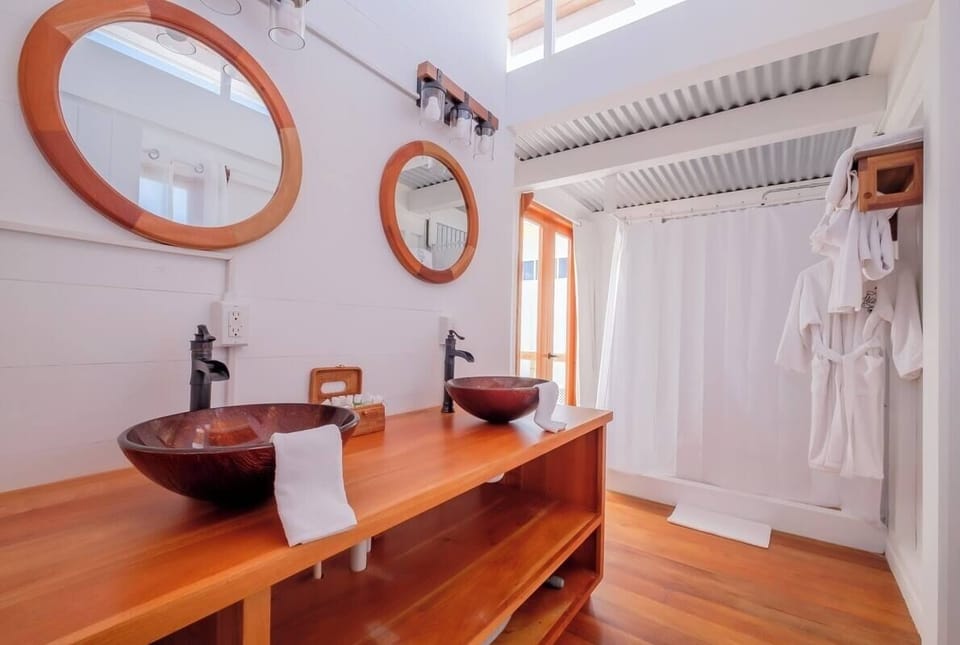 Refresh at the double vanity with warm wood finishes.