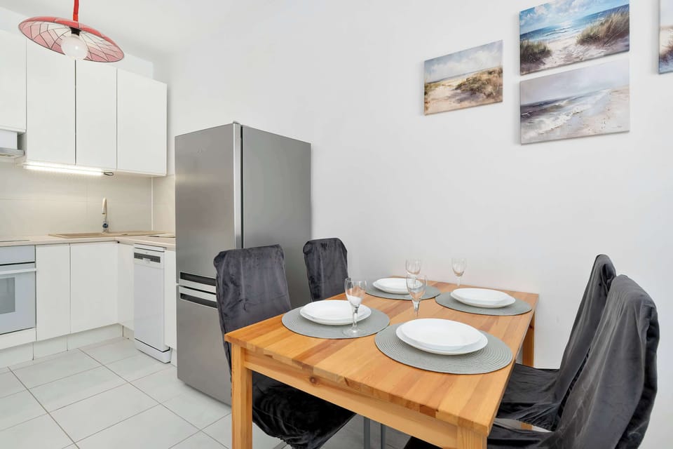 Modern dining and kitchen area with clean lines and neutral colors.