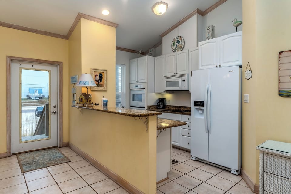 Your fully-equipped kitchen awaits with granite counters and modern appliances for memorable home-cooked meals.