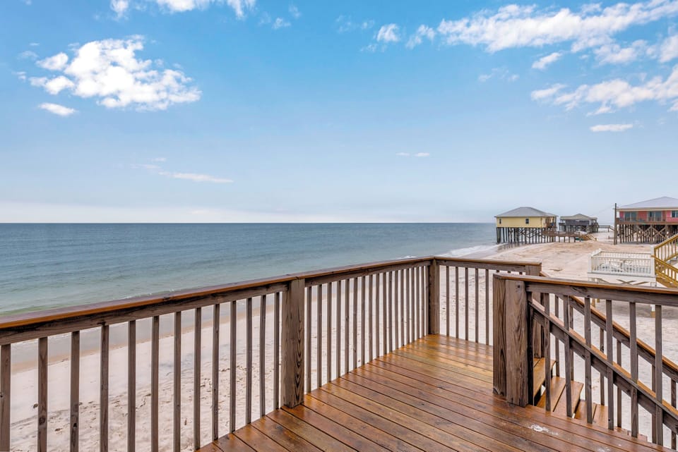 Private deck overlooking pristine beach with stunning ocean views - your perfect seaside retreat.