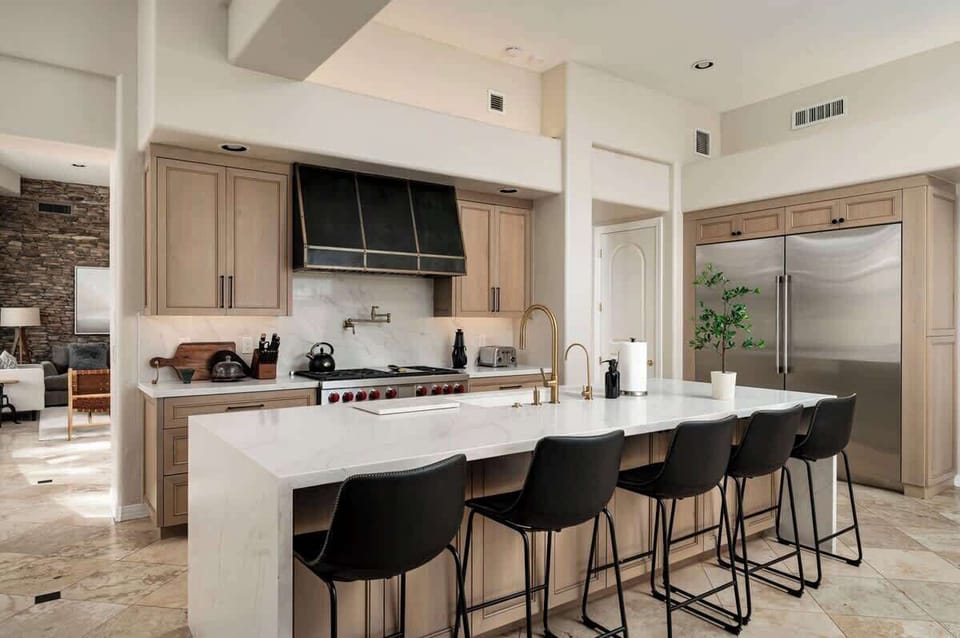 Your spacious gourmet kitchen features marble countertops, professional-grade appliances, and a breakfast bar where you can enjoy morning coffee.