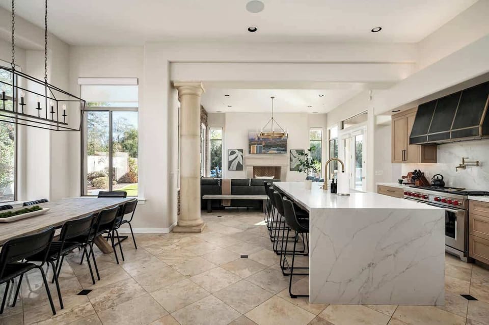 Your dream kitchen awaits with marble island seating, professional appliances, and open dining space for memorable meals together.