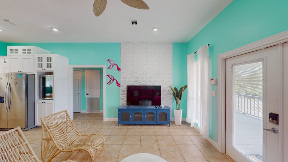 Mermaid details meet beach house comfort — sink into the sofa and let the waves inspire your stay.