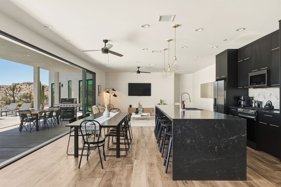 Stylish open-concept kitchen and dining with seamless patio access