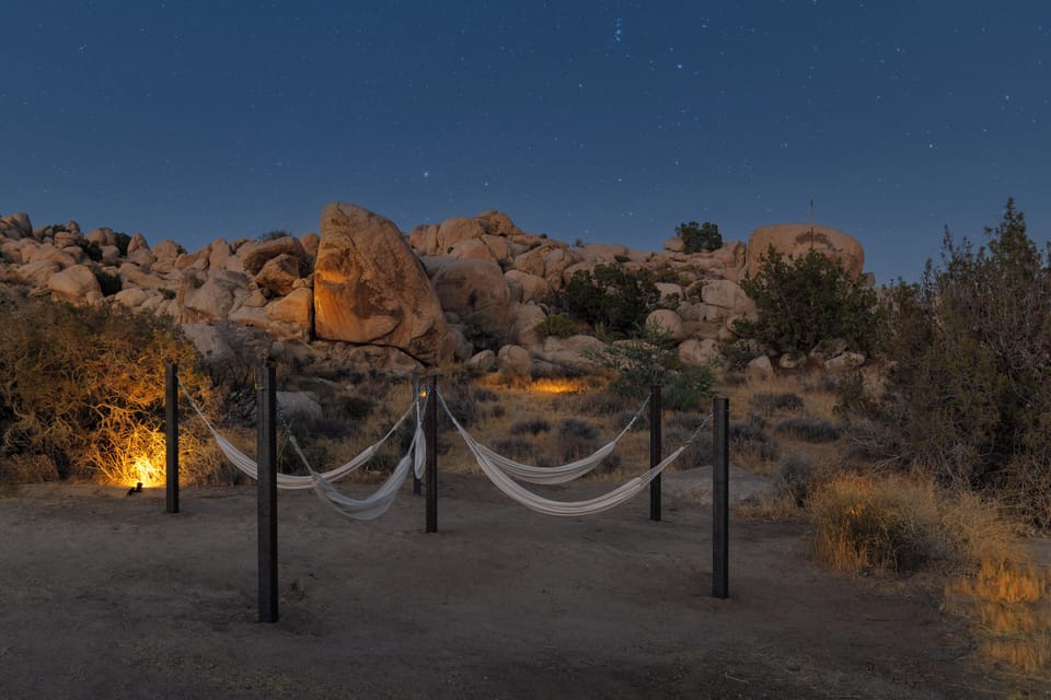 Stargazing hammocks nestled among glowing desert boulders