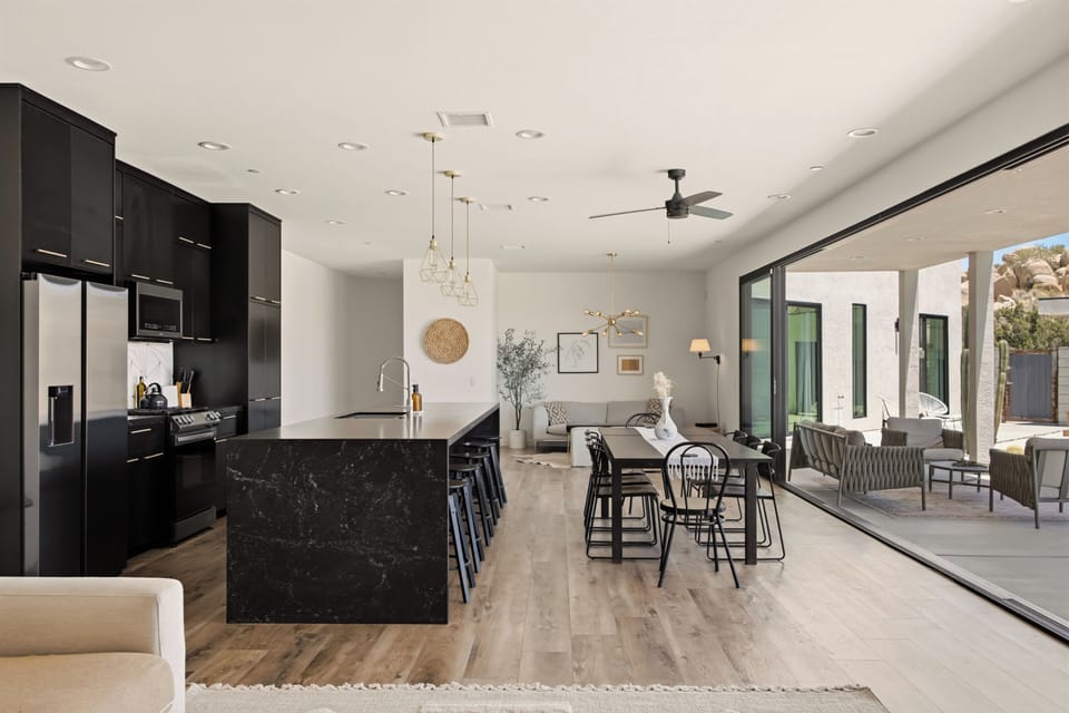 Modern open-concept kitchen and dining with seamless indoor-outdoor flow