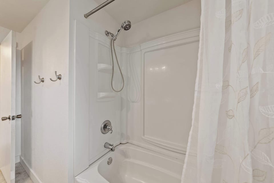 Relax in the full bathroom featuring a shower/tub combo