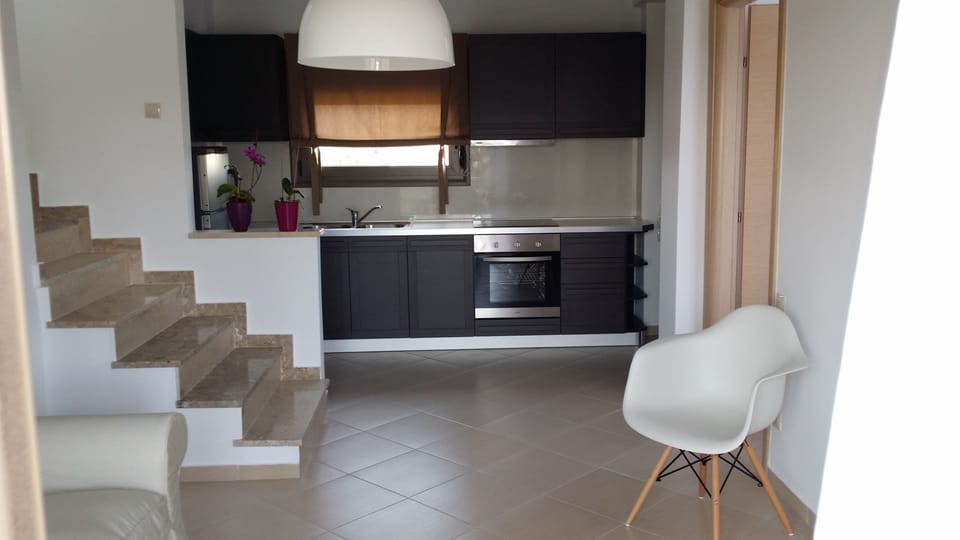 Deluxe Duplex, 2 Bedrooms | Private kitchen | Full-size fridge, oven, stovetop, coffee/tea maker