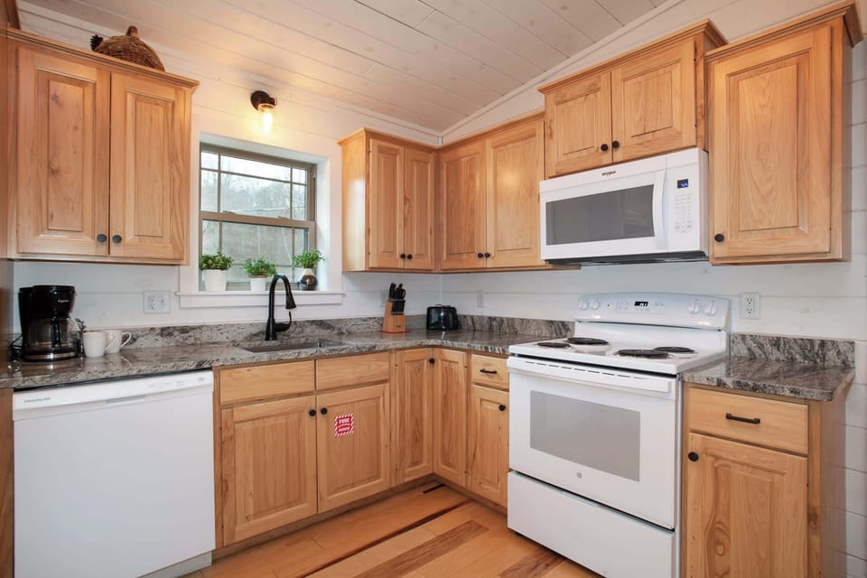 Whip up delicious meals in this fully equipped kitchen featuring granite countertops.