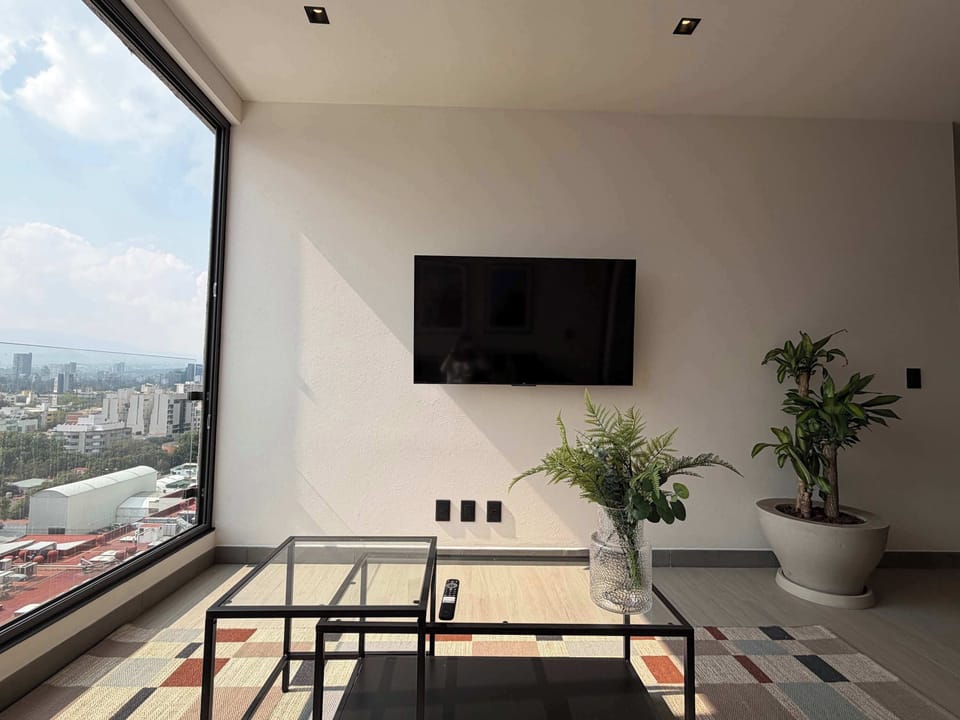Cozy living area with natural light and city skyline views.