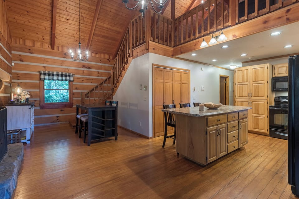 Kitchen and breakfast nook next stone wood burning fireplace
