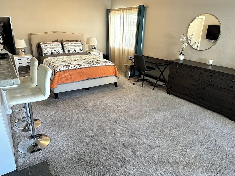 Open space bedroom with  a dedicated workspace.