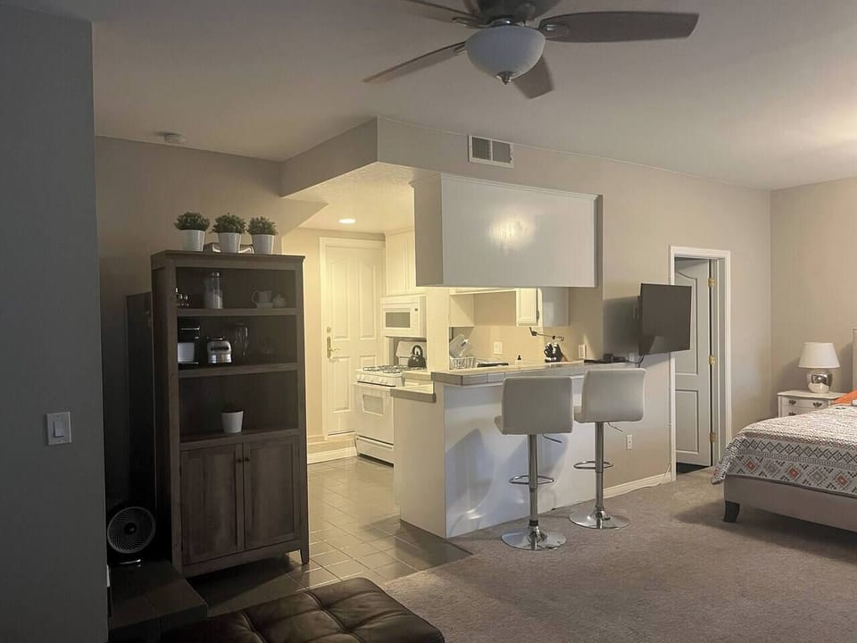 Well-equipped kitchen with everything you need to cook at home, plus two barstools for casual dining.