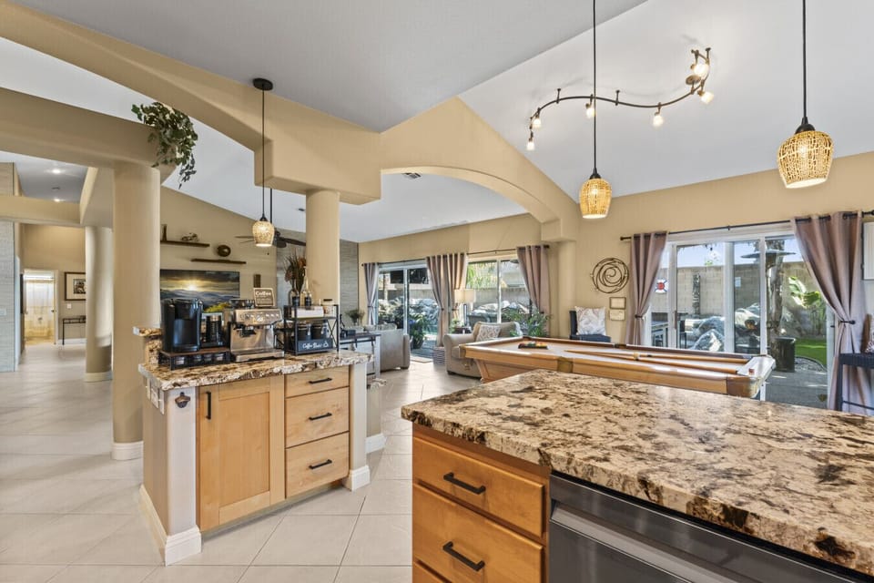 Bright kitchen w/ large island, granite counters & bar seating for casual meals