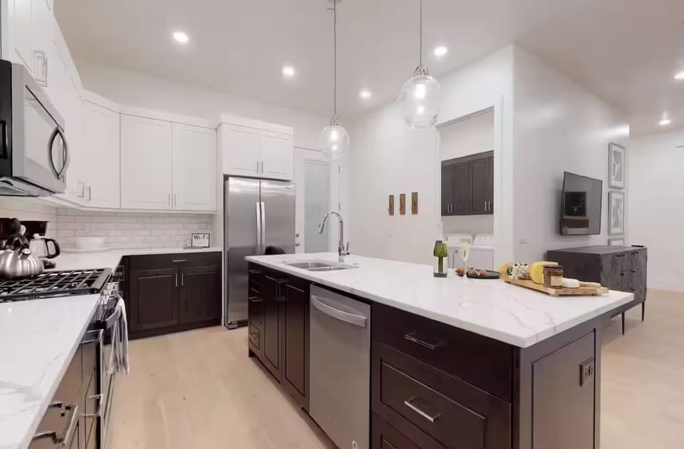 Fully Stocked Gourmet Kitchen Featuring Granite Countertops and Stainless Steel Appliances.