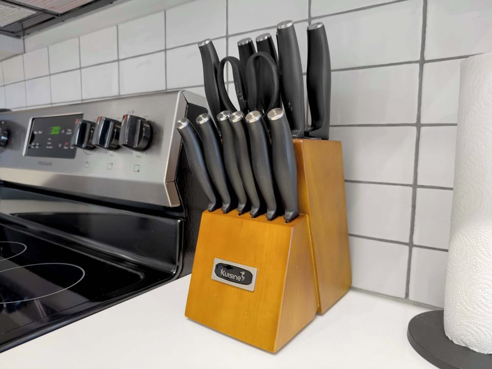 A fully stocked kitchen with high-end appliances, perfect for preparing meals during your stay. It includes everything you need, from a stovetop to a coffee maker, ensuring a smooth cooking experience.