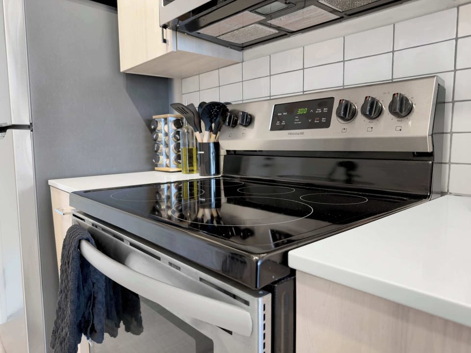 A well-equipped kitchen featuring modern appliances, perfect for preparing meals during your stay. From the stove to the coffee maker, this space is designed for functionality and ease, with plenty of counter space for cooking.