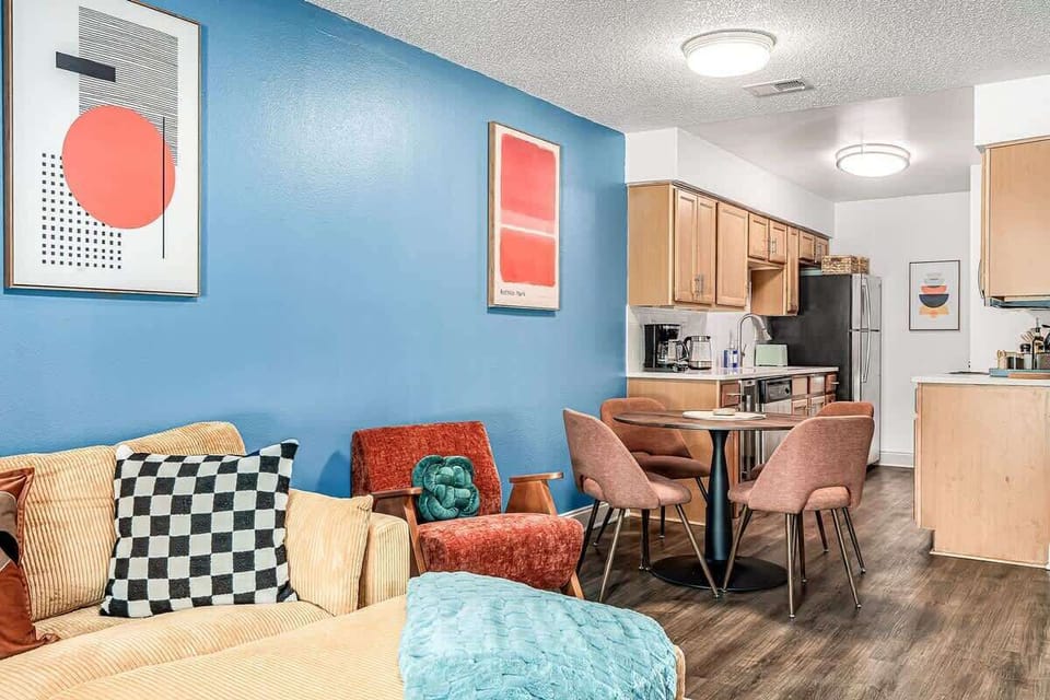 Modern open layout featuring a sleek kitchen, dining island, and vibrant lounge for comfortable gatherings.