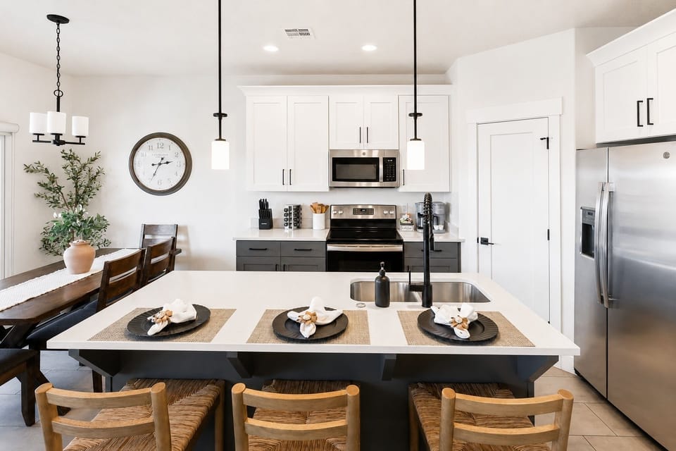 Bright modern kitchen with island seating for 4 and stainless appliances