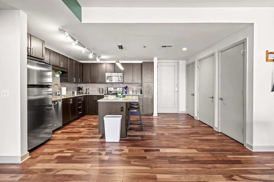Fully equipped kitchen with stainless steel appliances, granite countertops, and sleek cabinetry — perfect for cooking meals or enjoying morning coffee.