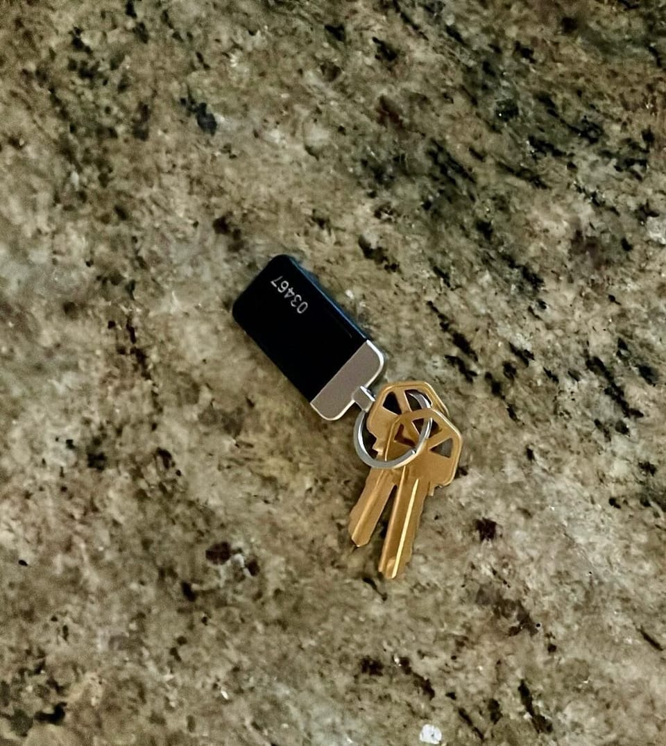A sleek set of keys with a modern black fob rests on a polished granite surface, capturing a clean, contemporary feel. A small but important detail that signals easy access, thoughtful design, and a smooth, stress-free stay from the moment you arrive