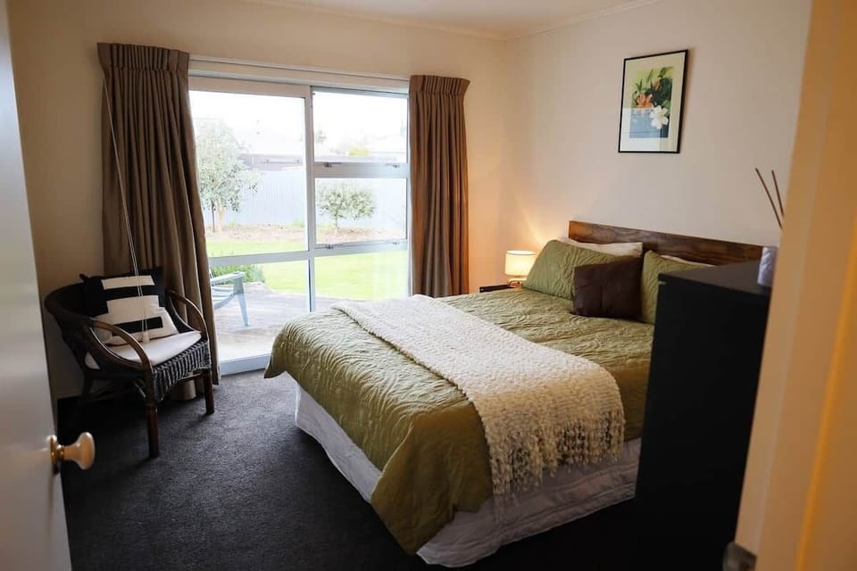 Restful Queen bed with a single wardrobe and private access to a morning coffee deck.