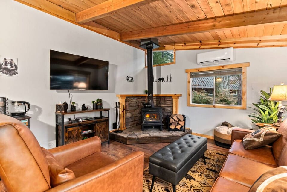 Living Room - Wood Burning Fireplace! Relax in the inviting living room, where a crackling wood-burning fireplace sets the perfect backdrop for cozy evenings after a day of adventure.  The 55` Roku TV is perfect for streaming your favorite movie!