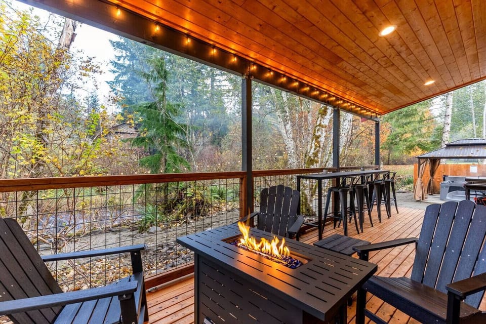 Covered Deck w/Fire Table & Creek Views!  Reconnect with nature and loved ones on the deck: soft lighting, a fire table, and the sights and sounds of the creek make it a peaceful escape!