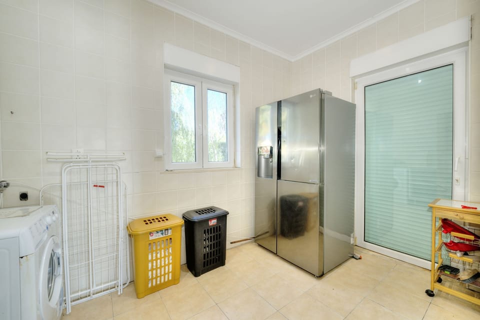 Laundry room next to kitchen