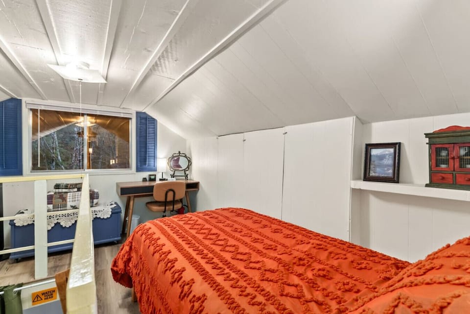 Upstairs Loft Bedroom - Dedicated desk allows remote work with a forest backdrop.