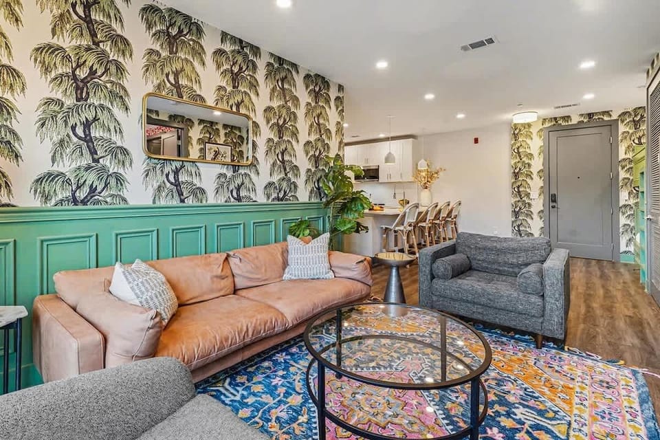 Bright and open living space featuring a picture frame smart TV and cozy furnishings.