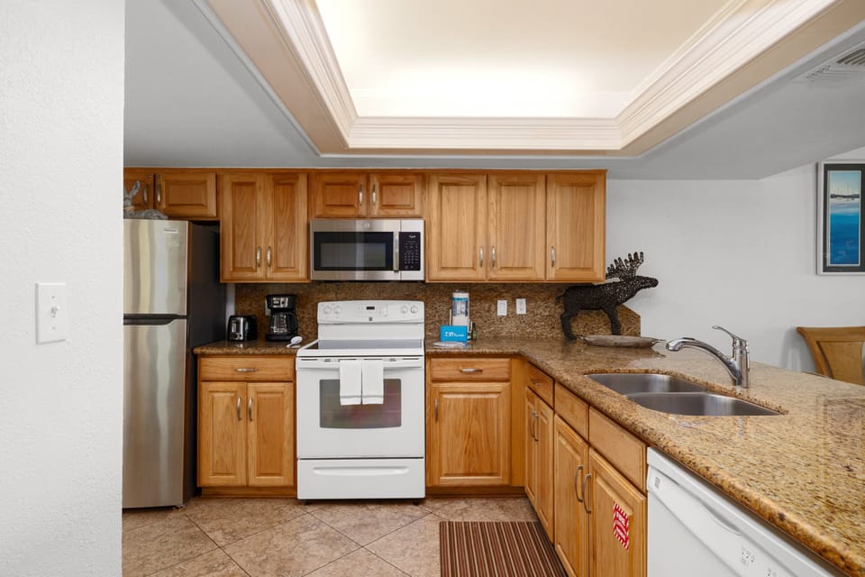 Fully equipped kitchen with granite counters and everything you need to cook at home