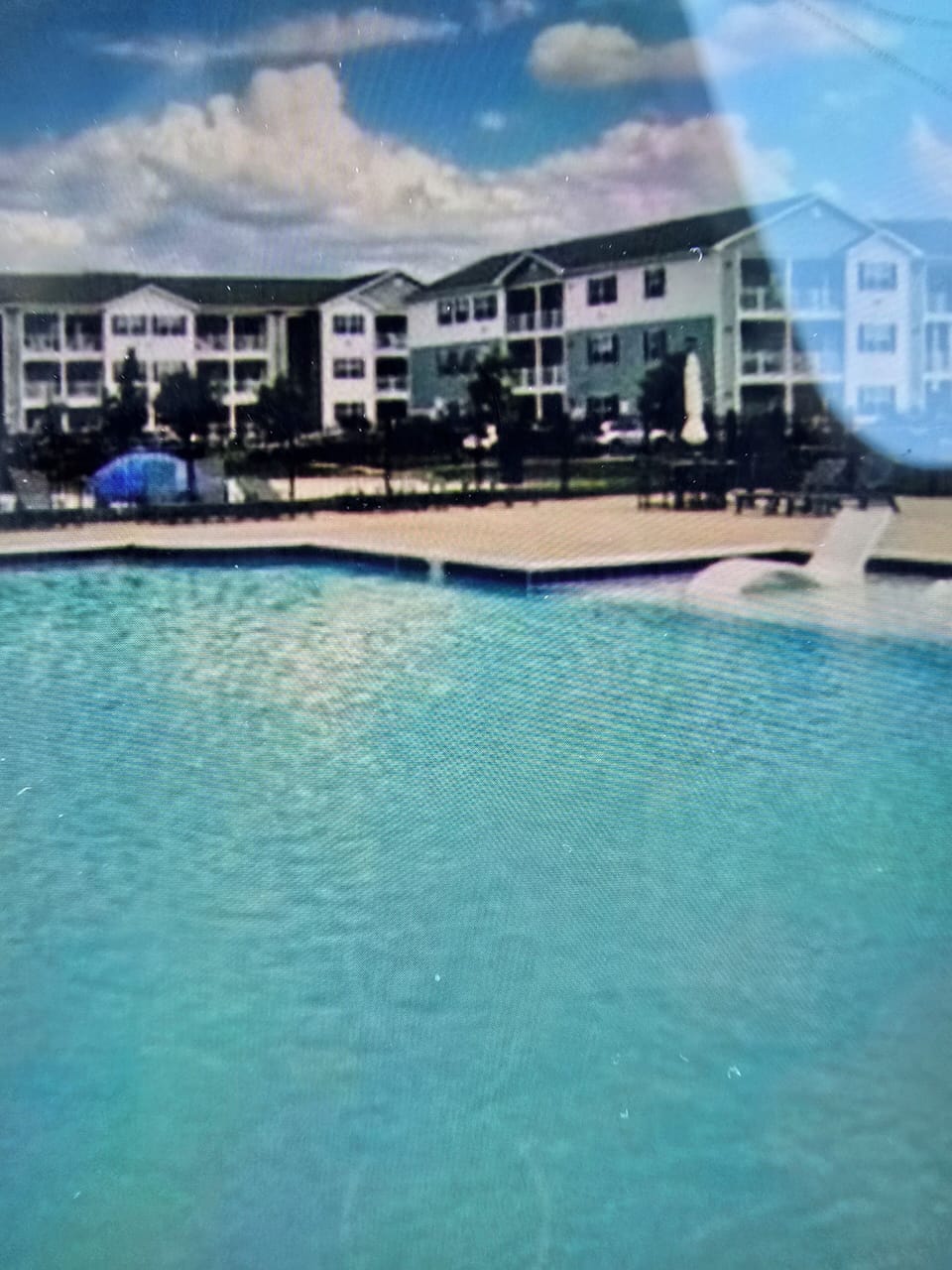 beautiful pool with plenty of lounge chairs (2  in the water).