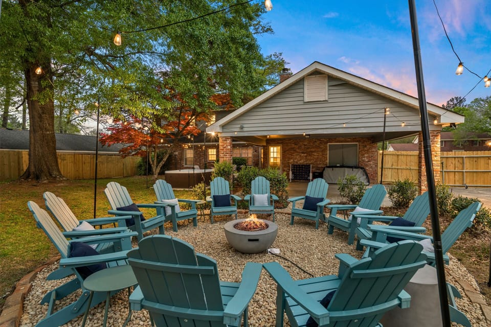 Cozy up with loved ones next to the warm fire. 12 chairs under string lights.