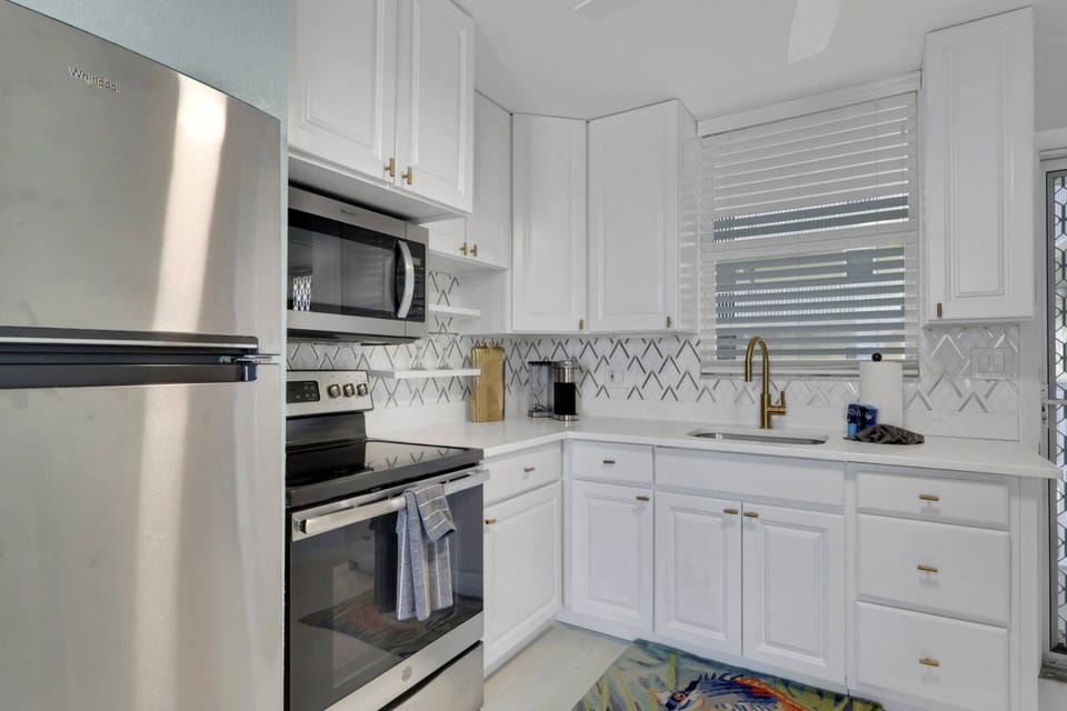 Cookware, dinnerware, kitchen tools and small appliances are provided, including a Keurig coffee maker.