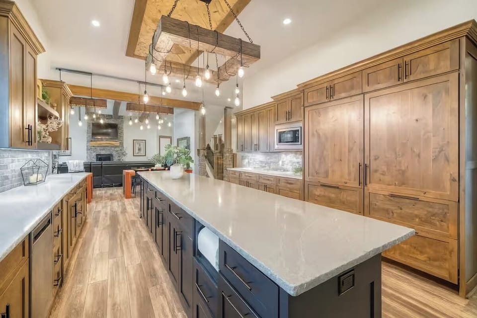 Open-concept kitchen with oversized island and modern finishes for gatherings.