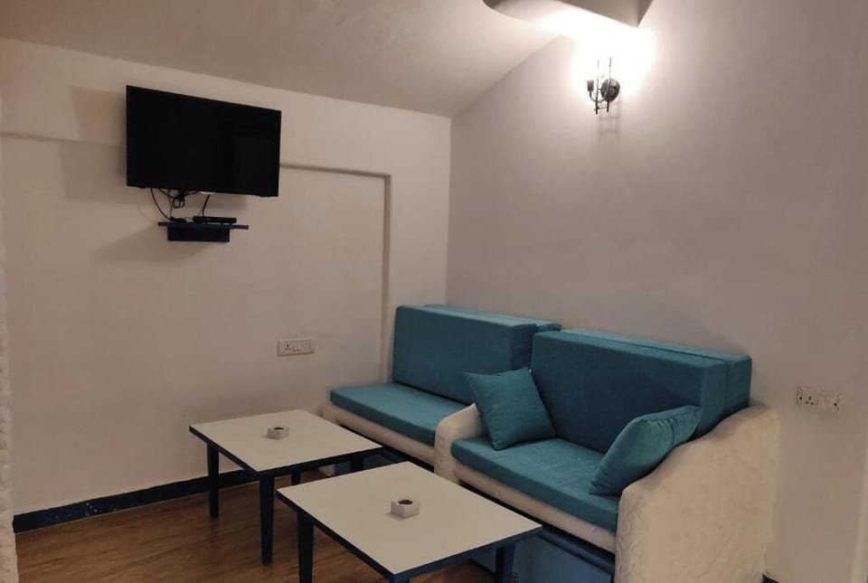 Family Quadruple Room, Balcony | Living area | 32-inch flat-screen TV with satellite channels