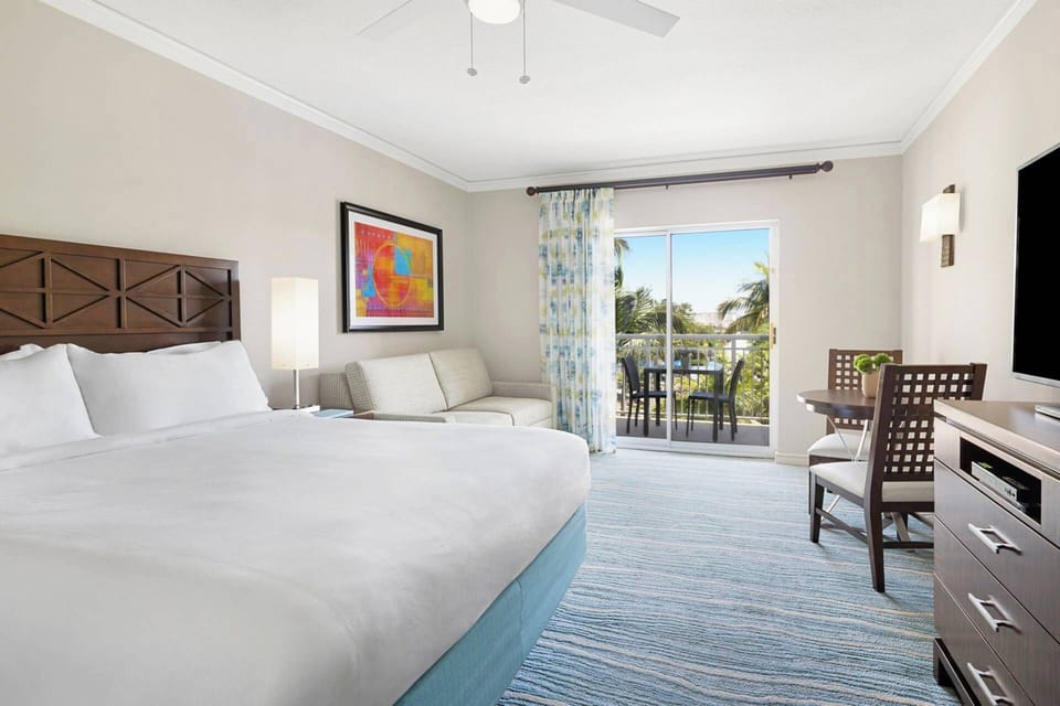 Guest Bedroom features a queen bed, sleeper sofa, small dining area for 2, a kitchenette, ensuite bath, and a balcony (view varies)