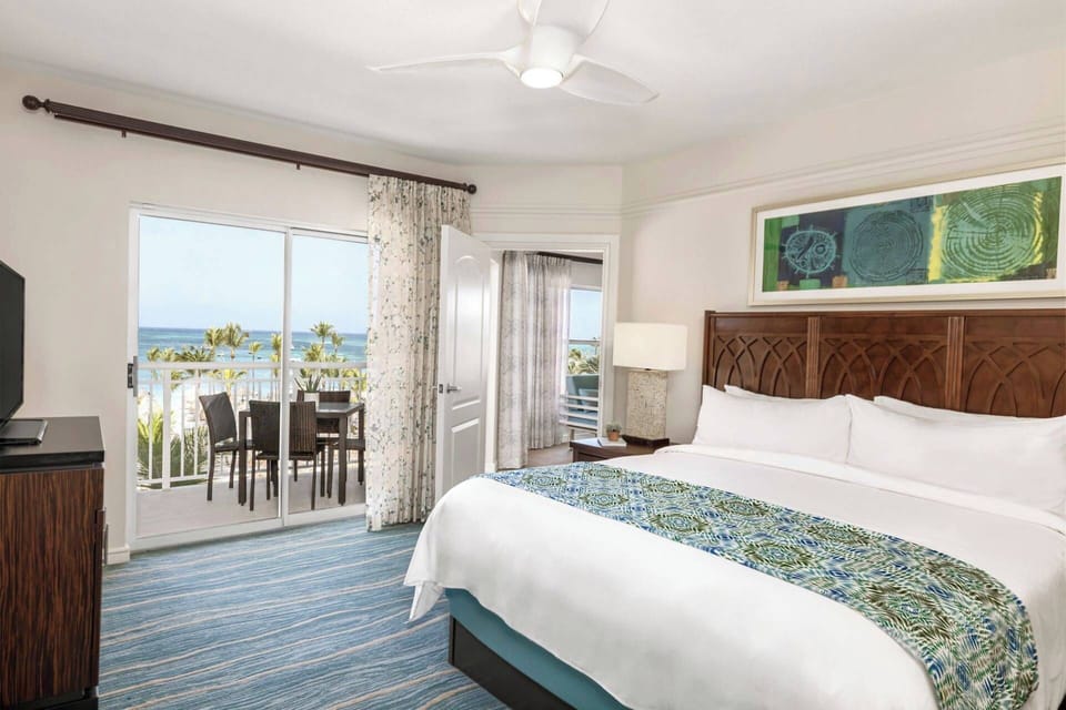 Primary Bedroom features a king bed, door to the private balcony, and an ensuite bathroom (oceanfront view).