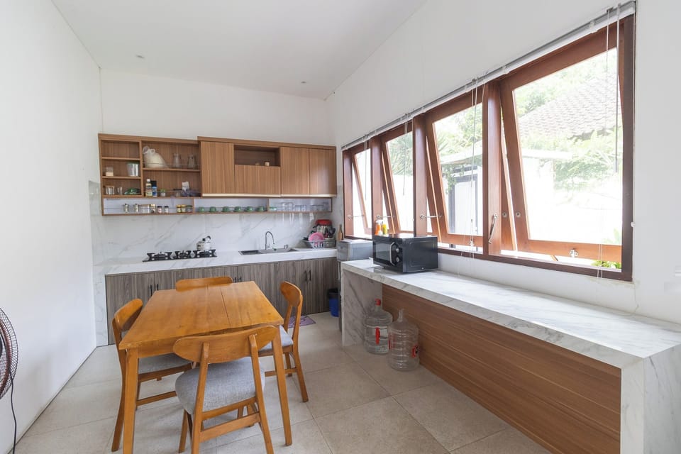 Deluxe Double Room | Private kitchen | Fridge, microwave, dining tables