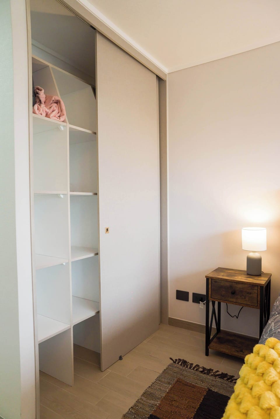 Warm and inviting bedroom corner with ample storage and cozy lighting, perfect for unwinding after a day of exploring.