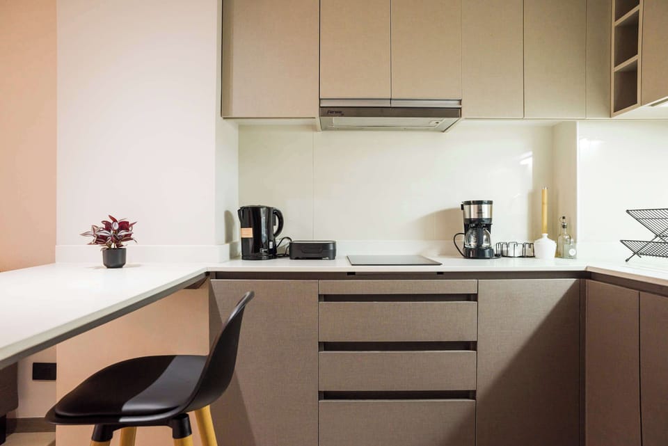 Modern kitchen equipped with essentials, perfect for culinary enthusiasts in a cozy studio setting.