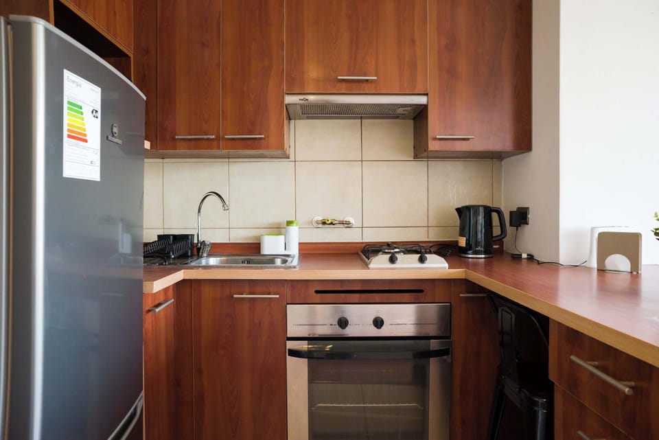 Sleek kitchen with modern appliances and ample storage, perfect for culinary adventures.