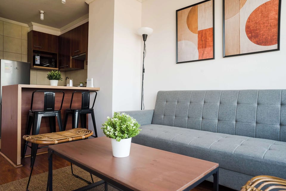Modern and inviting living area with stylish decor and a cozy sofa, perfect for unwinding after a day in the city.