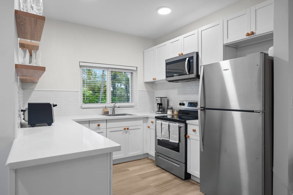 Kitchen is equipped with appliances, kitchenware, utensils and tools.