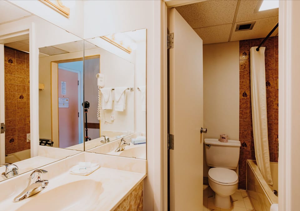 Room, 2 Queen Beds | Bathroom | Combined shower/tub, hair dryer, towels, soap