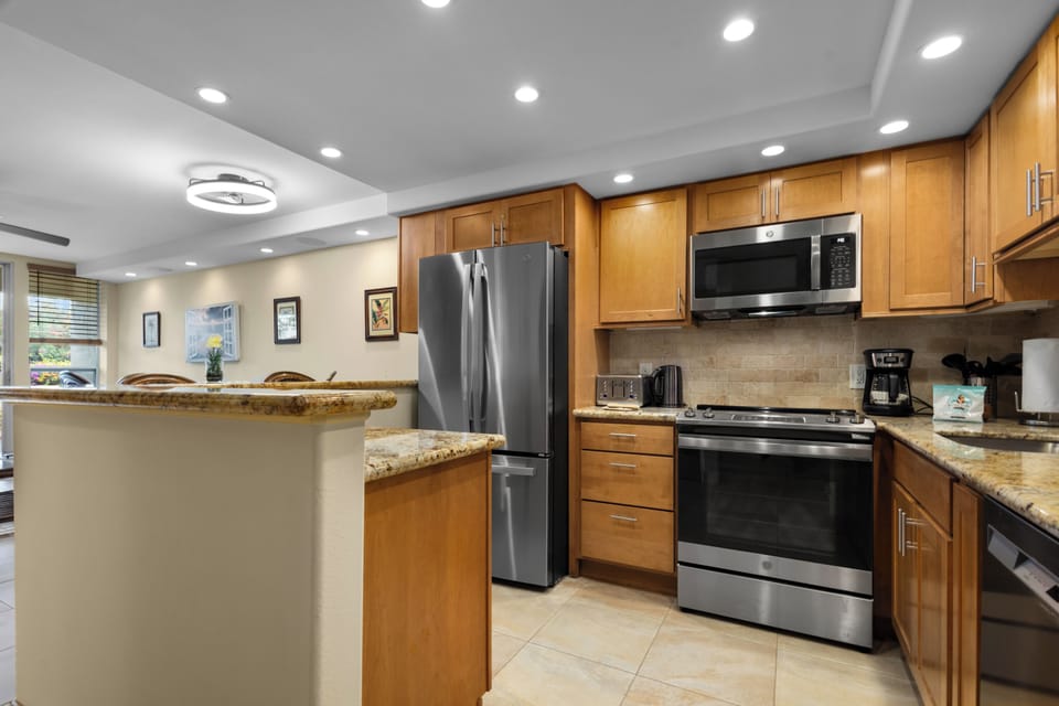 Cook your favorite meals in this fully equipped kitchen with granite counters, stainless appliances, and breakfast bar seating.